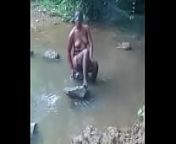 hot african woman taking bath from hot boudi bathing outdoor