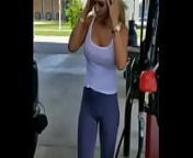Bra less girl filling gas from top less